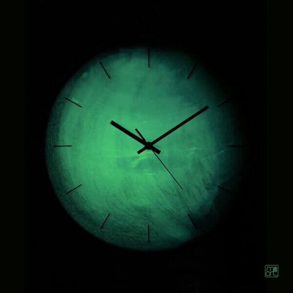 Neptune wall clock glowing green in complete darkness, with black hands visible against the illuminated surface.